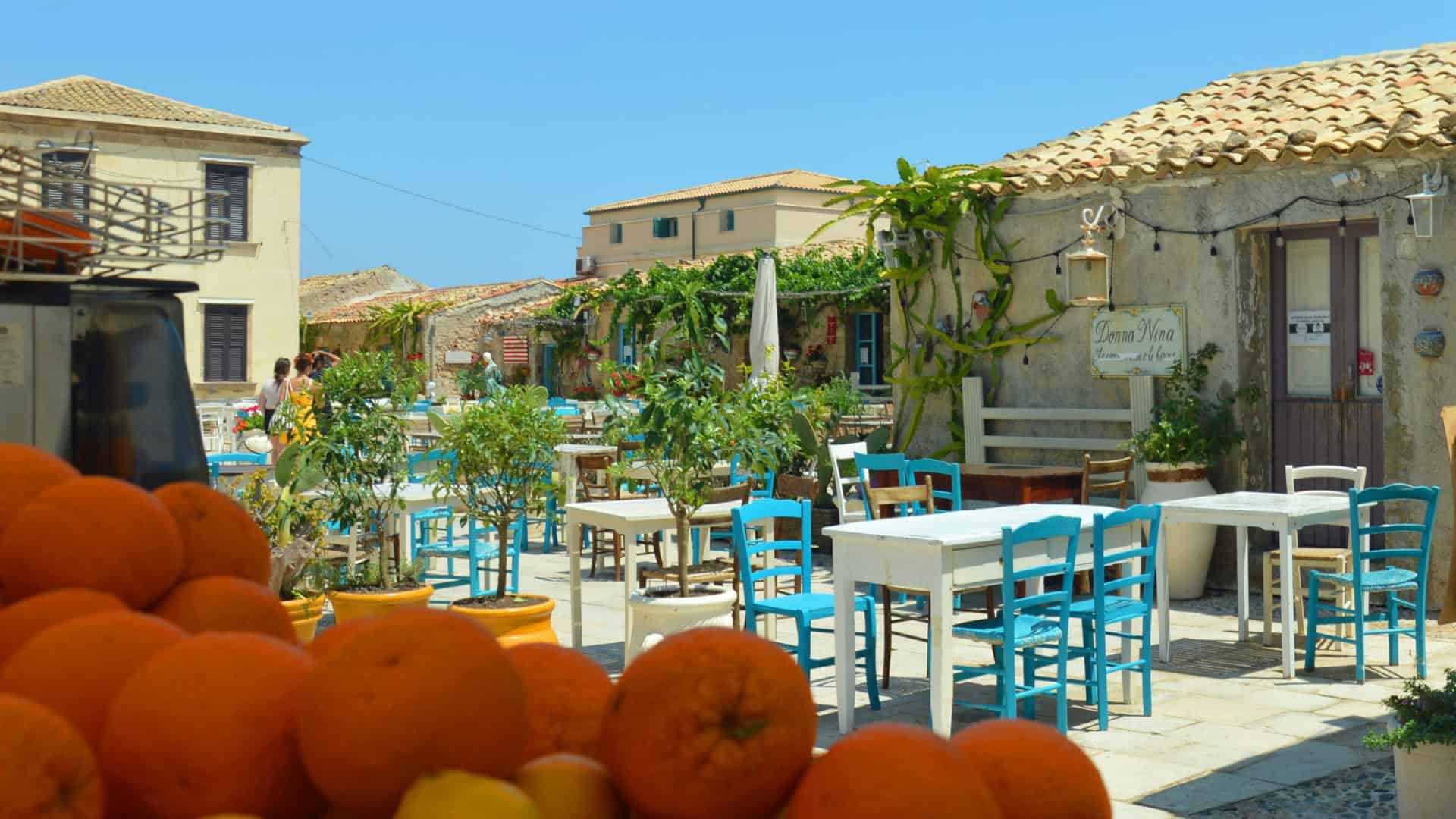 Square with tables and chairs in Marzamemi