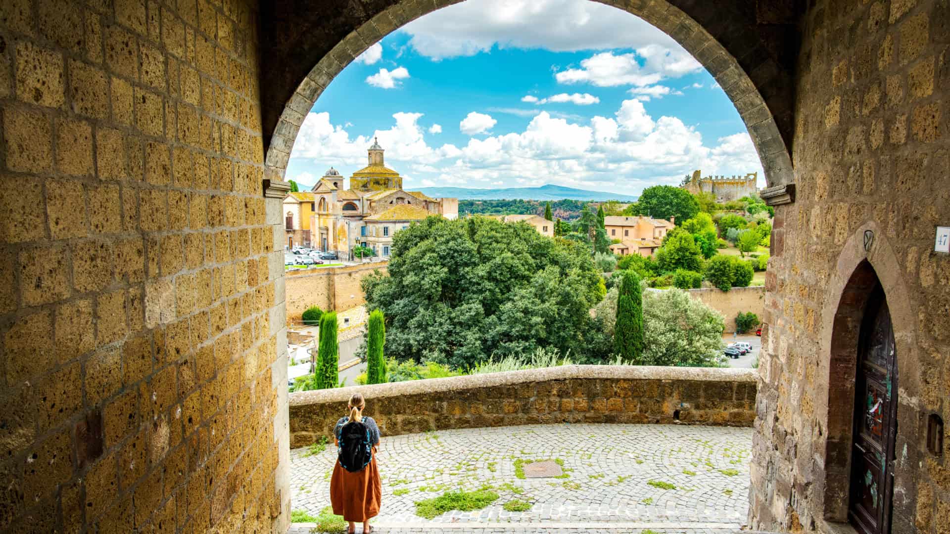 View of Viterbo with a woman walking under an arch