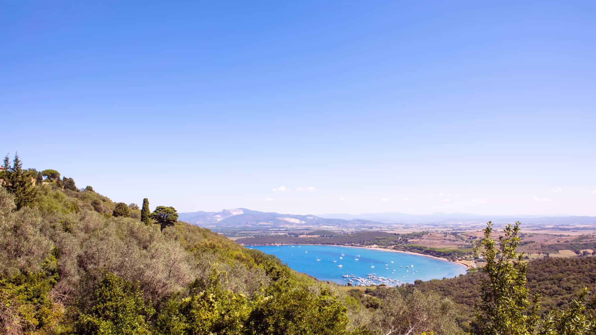 Distant panoramic view of Baratti beach in the Gulf of Baratti in Tuscany